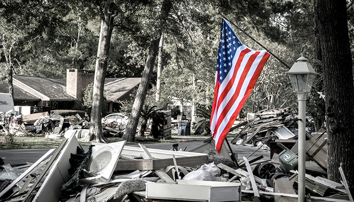 Image of hurricane damage and American Flag.